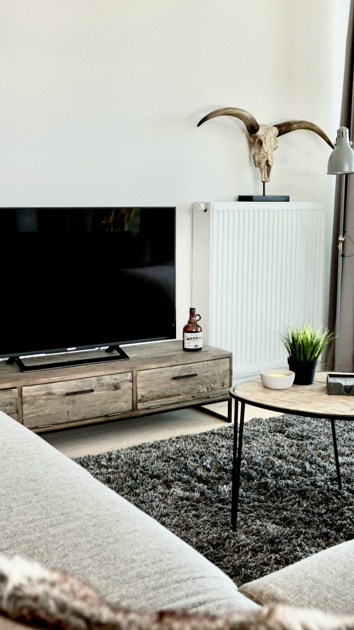 black flat screen tv on brown wooden tv rack